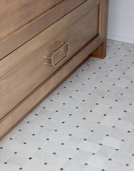 Screenshot 2026-05-25 at 95836 AM Wooden dresser drawer with a geometric metal handle, set on a light gray tiled floor.